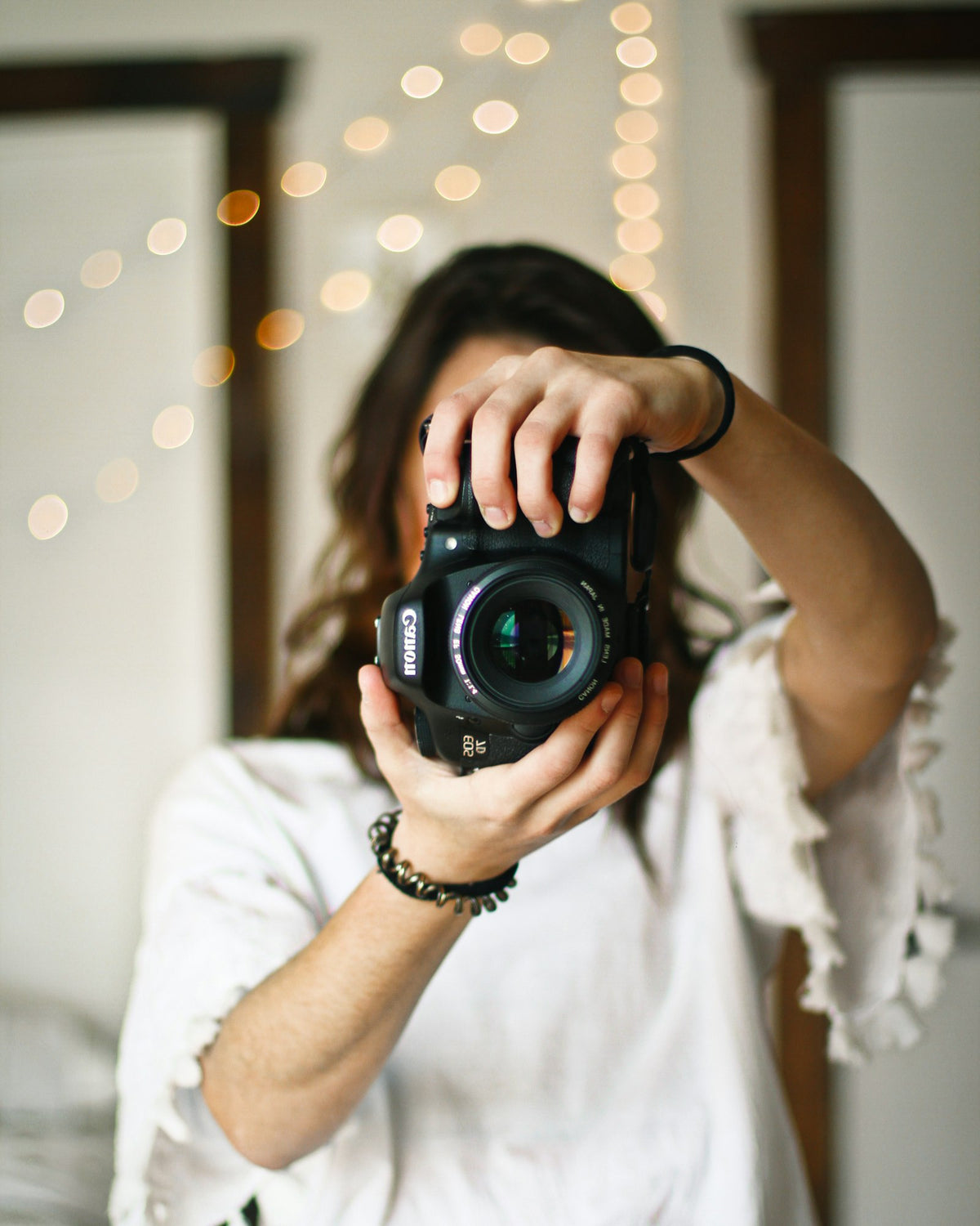 Woman learning to frame a shot with a camera
