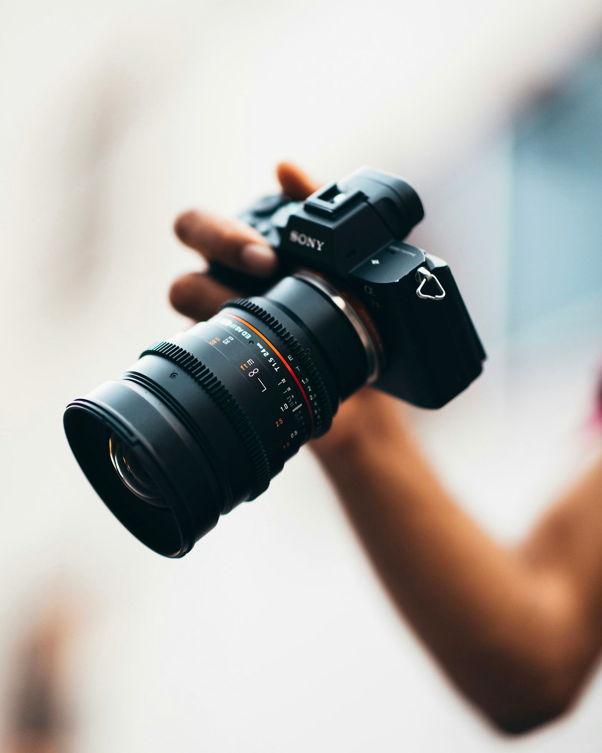 Photographer holding a camera in bright natural light