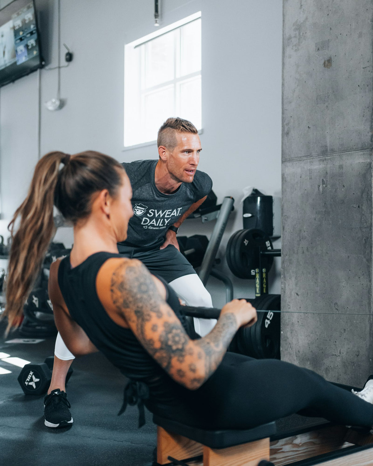 Personal trainer guiding a client through an exercise