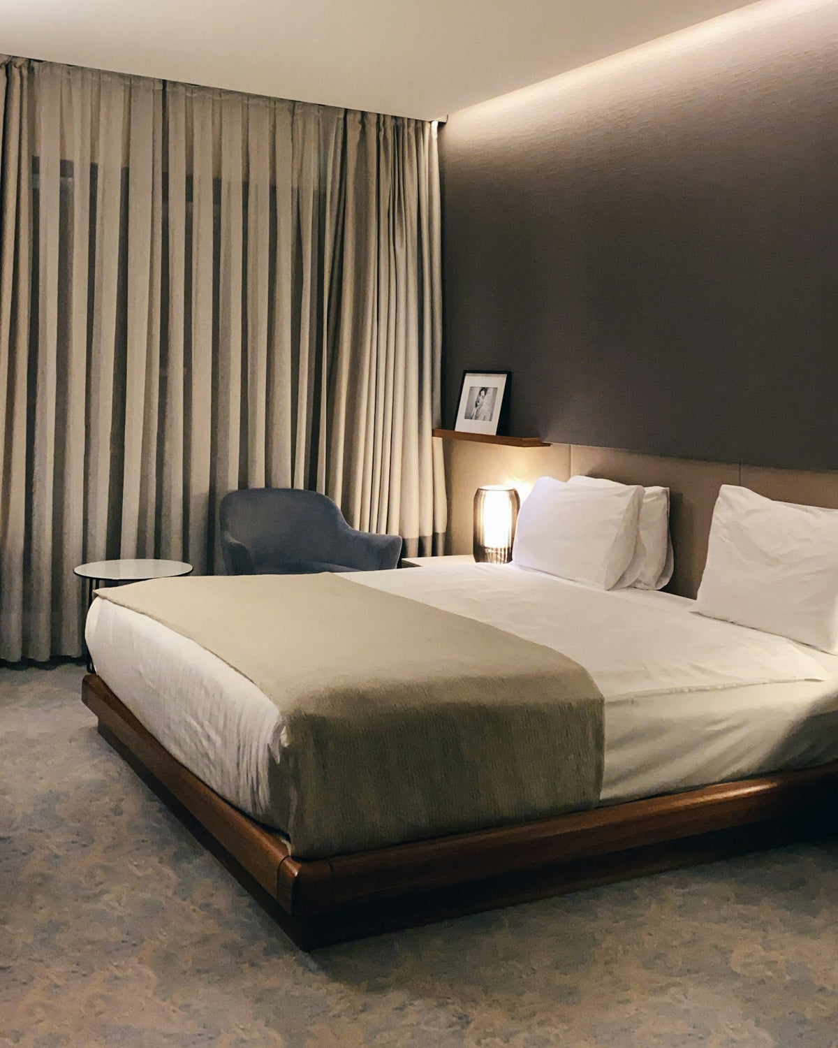 A calm hotel room with a neatly made bed
