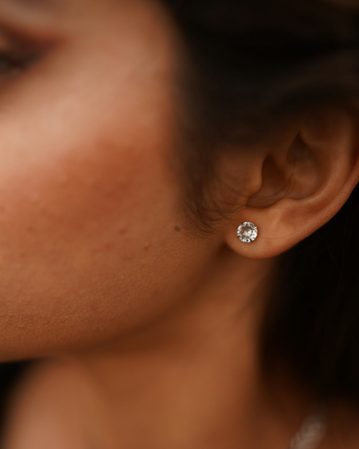 Close-up of a stud earring in an earlobe