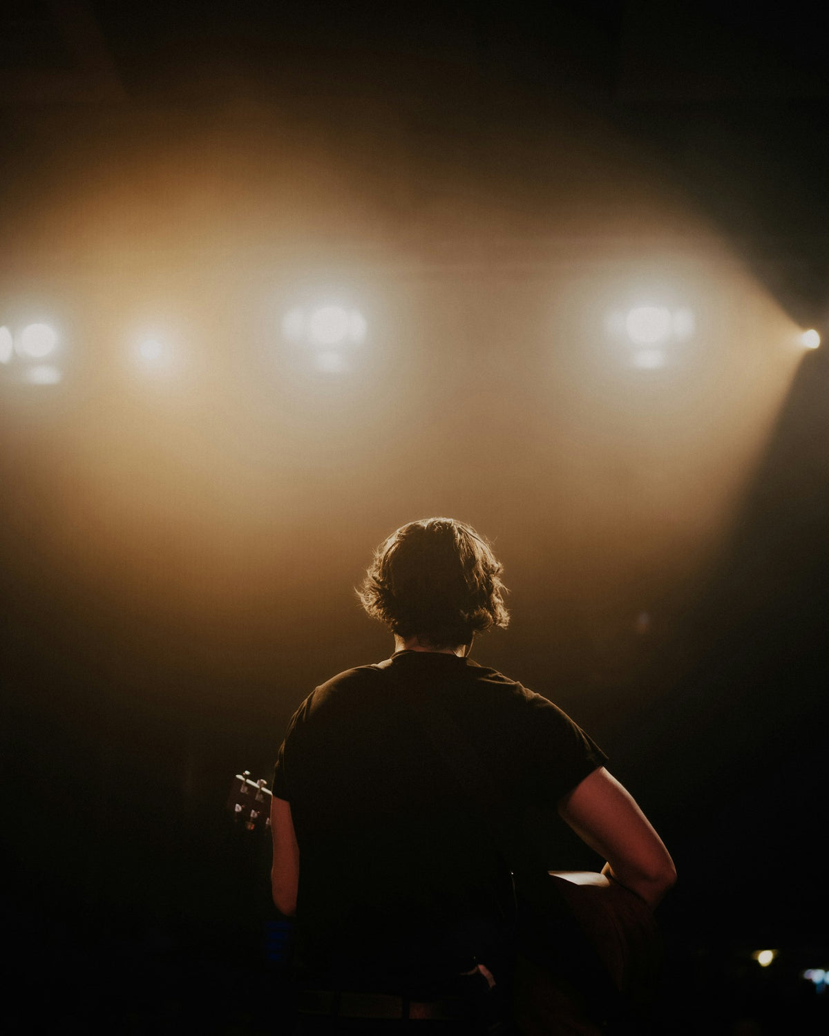 Audience watching a live show in warm stage light