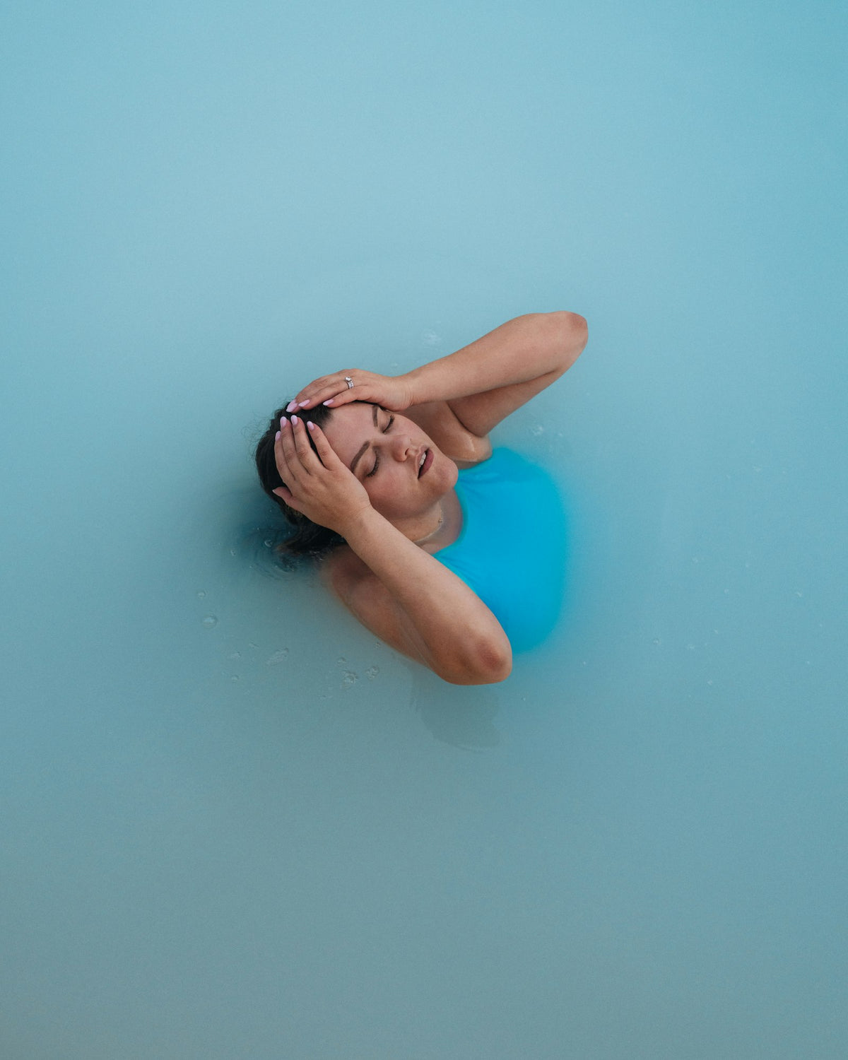Woman floating in warm, milky thermal water