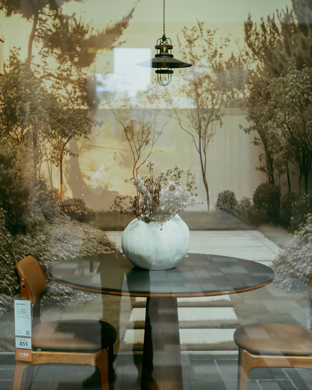A round table and wooden chairs in a calm design showroom