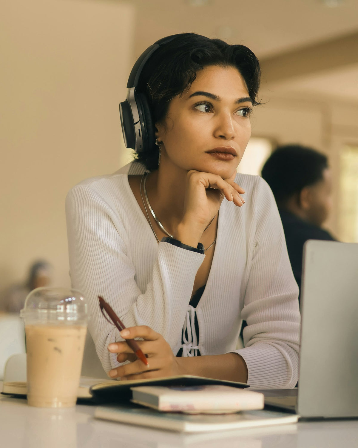 Woman with a headset on a call at a bright desk